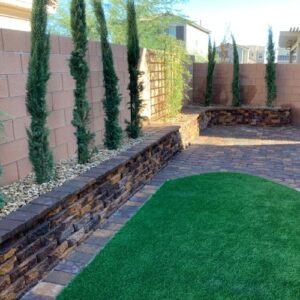 Astro Turf Installation With A Retaining Wall & Trees