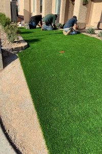 Landscapers Installing Artificial Grass At A Las Vegas Home