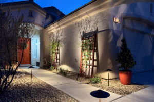 Front Yard Landscape Lighting Illuminating A Home Walkway And Entryway With Modern Path Lights And Wall Accent Lighting In Las Vegas.