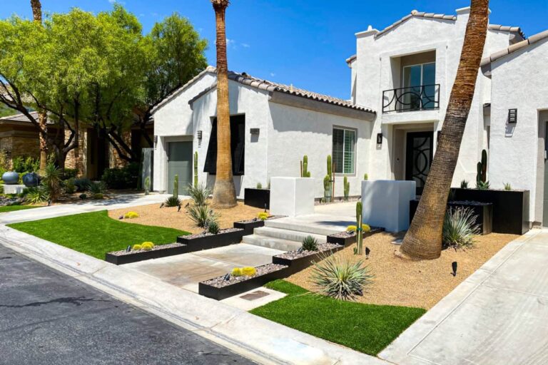 Front Yard Desert Landscaping With Decorative Rock, Artificial Grass, Drought-Tolerant Plants, And Clean Modern Lines In Las Vegas.